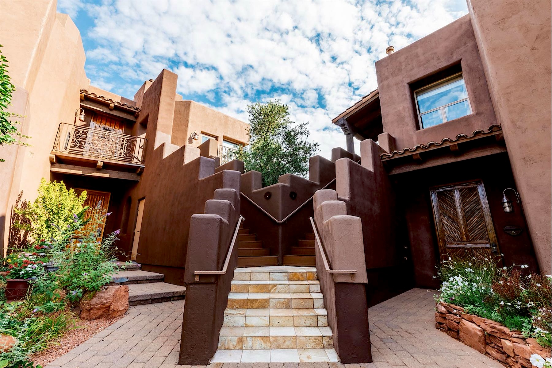 Adobe stairway between villas under a blue Sedona sky