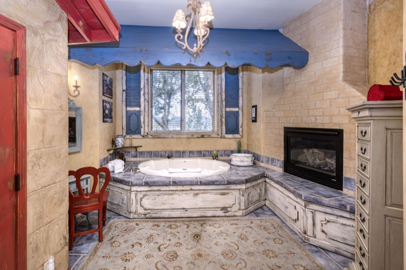 French Quarter villa jetted tub beside a fireplace