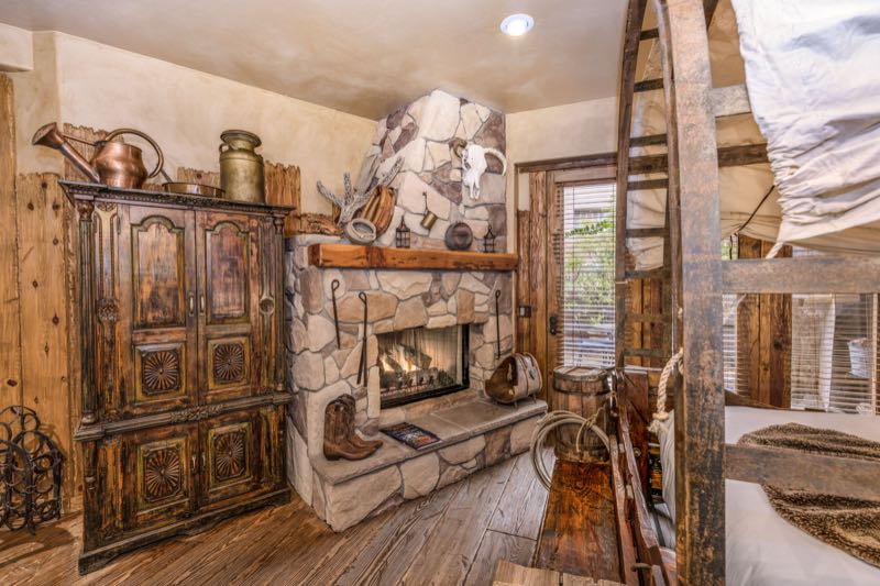 Wagon Wheel villa stone fireplace and antique armoire