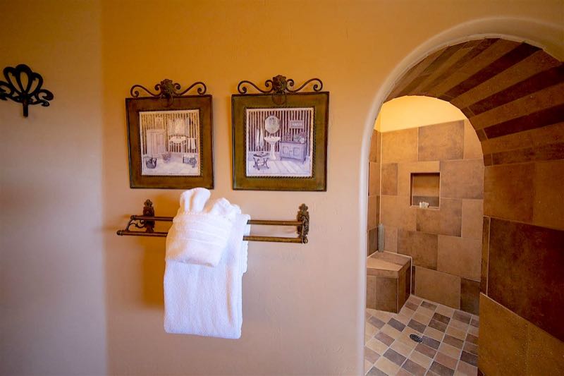 White Dove villa bathroom with an arched walk-in shower